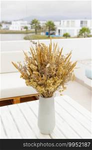 Cute bouquet of dried flowers  Bunny tail  on the terrace of a house