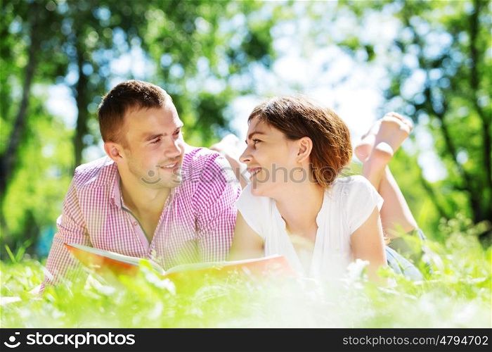 Cute boy and young woman in summer park. Weekend in park