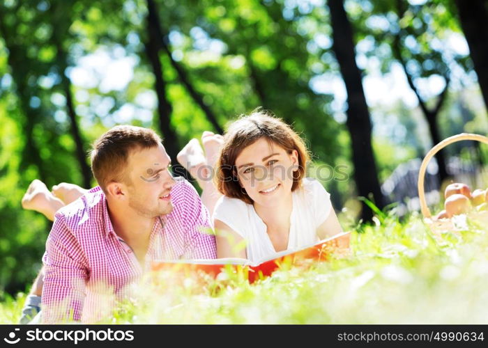 Cute boy and young woman in summer park. Weekend in park