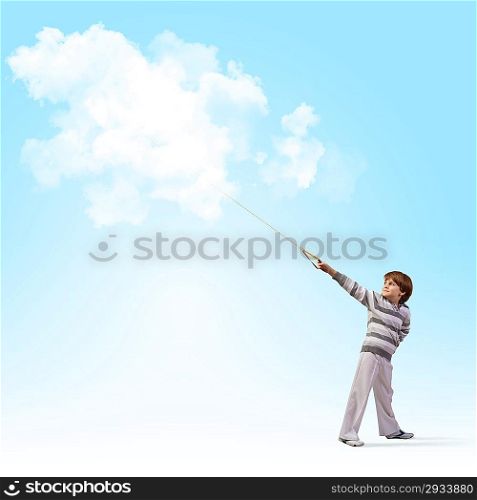 Cute boy catching clouds