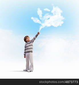 Cute boy catching clouds. Image of little cute boy catching clouds in sky