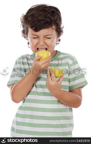 Cute boy eating lemon over a white background