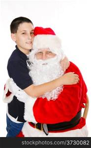 Cute boy giving Santa Claus a hug. Isolated on white.
