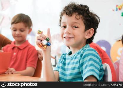 Cute boy in kindergarten classroom, kid education concept