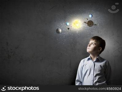 Cute boy of school age exploring space system. I will be astronaut