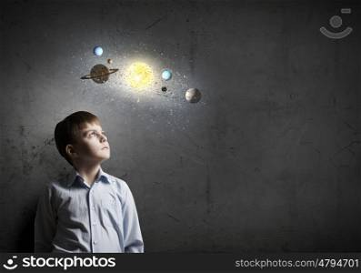 Cute boy of school age exploring space system. I will be astronaut