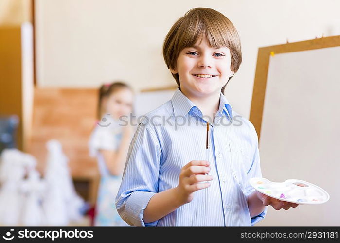 Cute boy painting