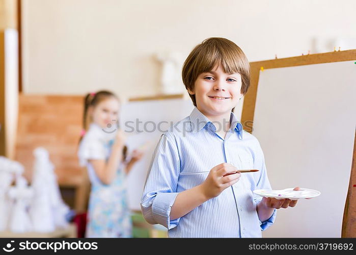 Cute boy painting