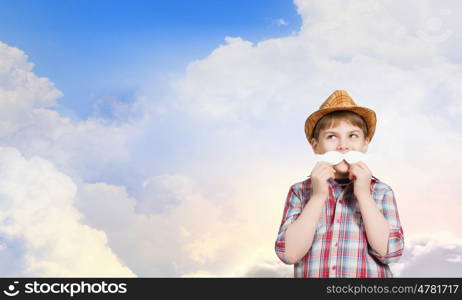 Cute boy wearing shirt hat and mustache. Kid having fun