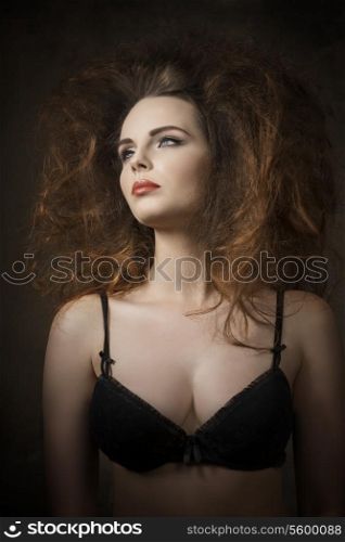 cute brunette girl posing in fashion shoot with volume fashionable hair-style, red lipstick and black bra