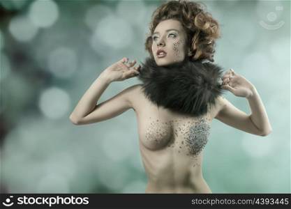 cute brunette girl with elegant hair-style and fur collar posing with her naked body decorated by piece of shiny mirrors