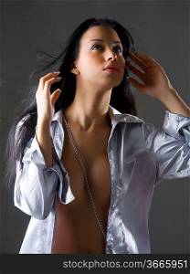 cute brunette latina with long black hair and gray shirt taking pose