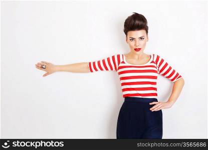 cute brunette woman with hand on wall