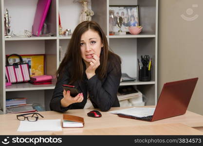 Cute business woman in the office at the computer