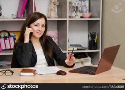 Cute business woman in the office at the computer