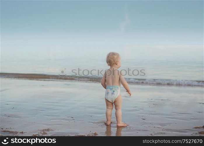 Cute, calm baby watching an ocean&rsquo;s wave