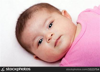 Cute Caucasian Hispanic Latina baby face. Beautiful head of a newborn infant.