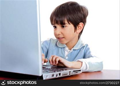 Cute caucasian kid working in laptop on isolated white background