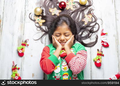 Cute cheerful smiling girl with decorated Christmas hair