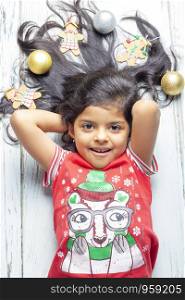 Cute cheerful smiling girl with decorated Christmas hair