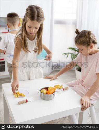 cute children playing with cooking game