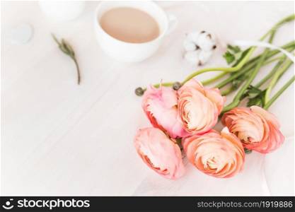 Cute close-up photo of a coffee cup with flowers.. Cute vintage mock up on wooden background. Flat lay top view.