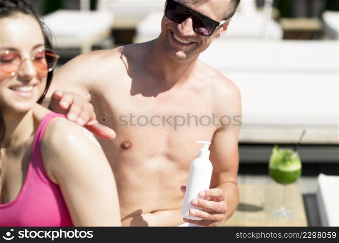 cute couple beach with sunscreen
