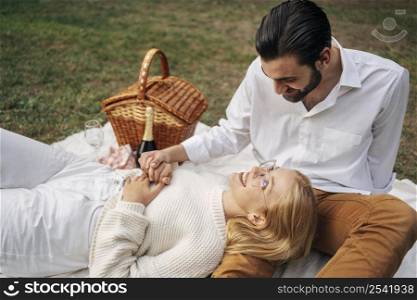 cute couple having picnic together outdoors