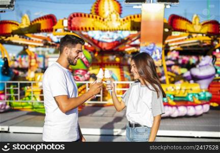 cute couple holding ice creams fair