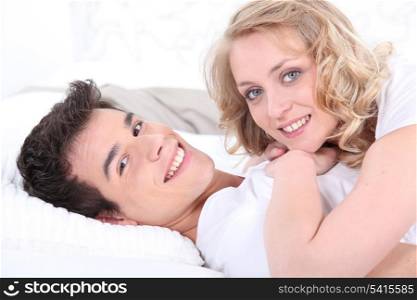 Cute couple laying on bed