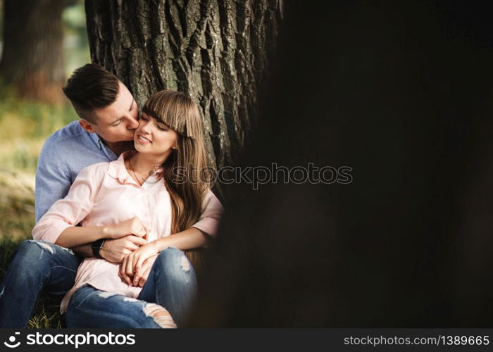 Cute couple walking near water. Girl in a white shirt. Pair by the river. Loving young couple near the river with boats. love without borders. selective focus.. Cute couple walking near water. Girl in a white shirt. Pair by the river. Loving young couple near the river with boats. love without borders. selective focus