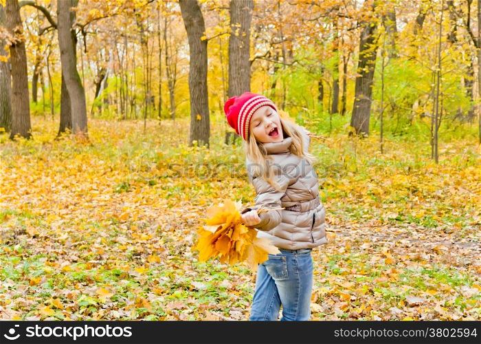 Cute dancing and singing girl in autumn