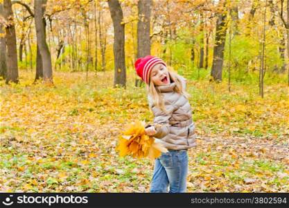 Cute dancing and singing girl in autumn