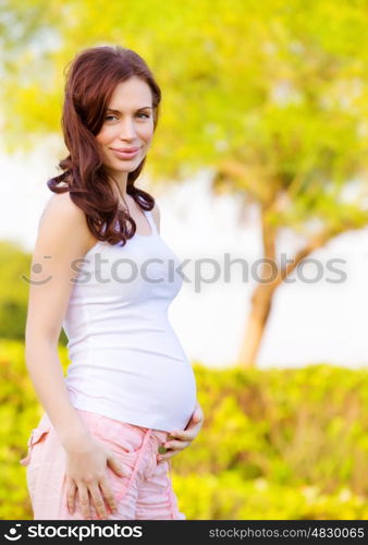 Cute expectant woman spending time outdoors in spring time, happy motherhood, healthy pregnancy, love concept&#xA;