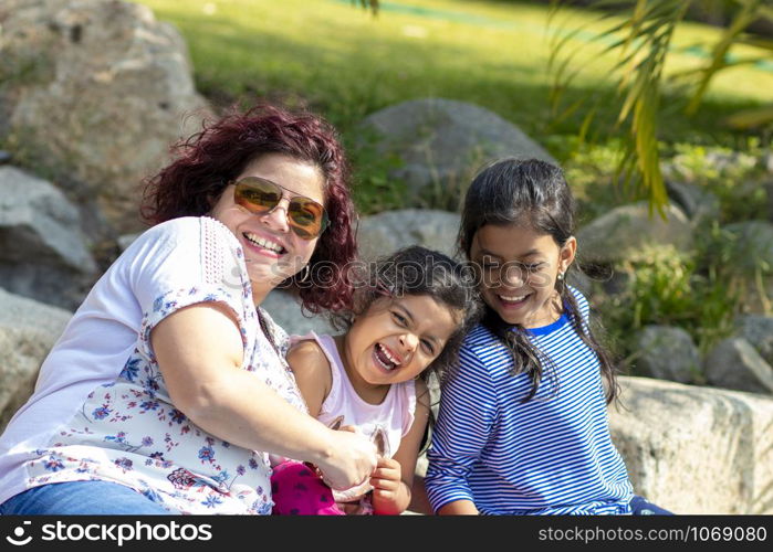 Cute family of mother and daughters in the garden