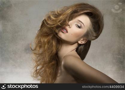 cute fashion portrait of sexy female in sensual pose with naked shoulders and creative bushy hair-style