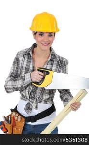 cute female carpenter using handsaw