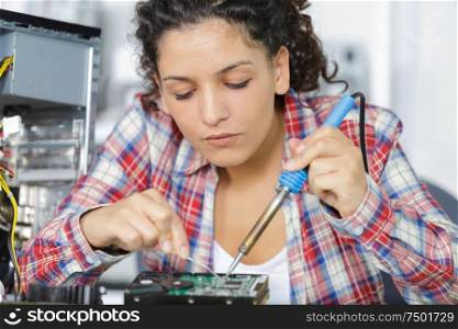 cute female engineer at home working on technology