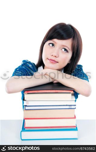 Cute female student resting on books and looking upwards