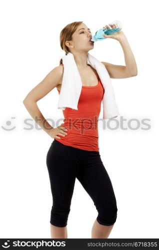 cute fitness woman drinking water. cute young fitness woman drinking water on white background