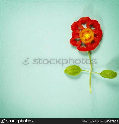 Cute flowers made of fresh organic vegetables on blue background - Cooking, Gardening, Raw Food, Vegetarian or Clean Eating concept