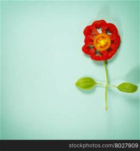 Cute flowers made of fresh organic vegetables on blue background - Cooking, Gardening, Raw Food, Vegetarian or Clean Eating concept