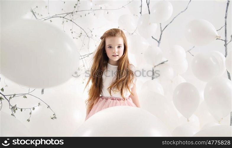 Cute girl among numerous white balloons