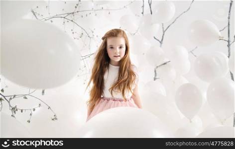 Cute girl among numerous white balloons
