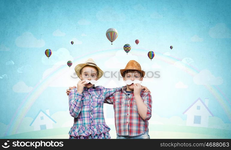 Cute girl and boy wearing shirt hat and mustache. Kids having fun