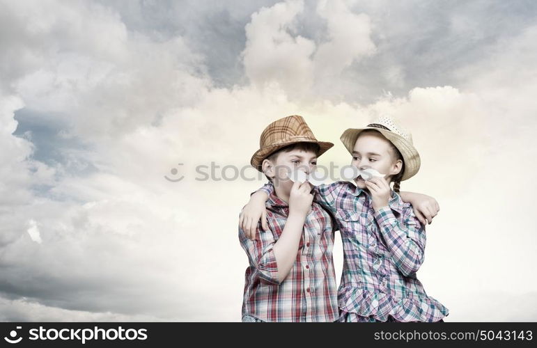 Cute girl and boy wearing shirt hat and mustache. Kids having fun