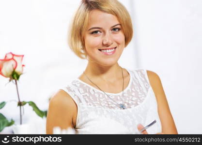 Cute girl at cafe. Portrait of young pretty woman sitting at cafe