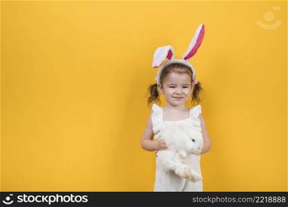 cute girl bunny ears standing with rabbit