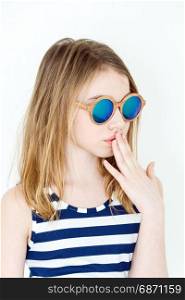 Cute girl eleven years old in green sunglasses on white