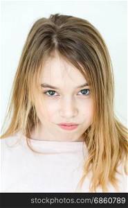 Cute girl eleven years old with blond long hair and green eyes